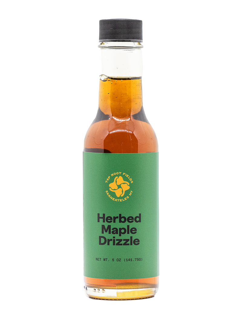Bottle of herbed maple drizzle on a white background